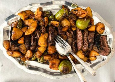 Selection of roast meat and vegetables on a silver serving dish